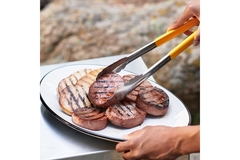 Image A person grills Meati Foods steak and cutlets on a grill.